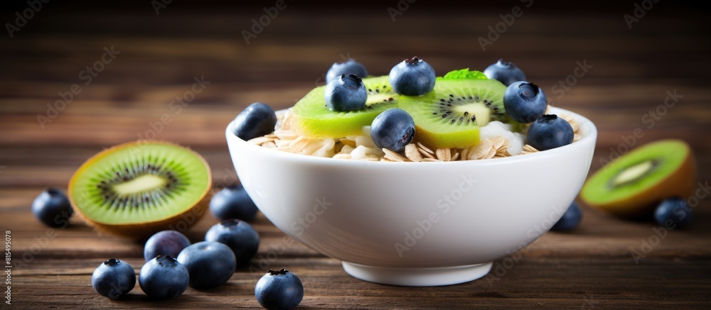 Poster a nutritious breakfast of oatmeal with blueberries and kiwi is beautifully presented on a wooden tab