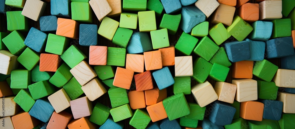 Poster top view of a copy space image showing colorful wooden blocks for children placed on a green carpet
