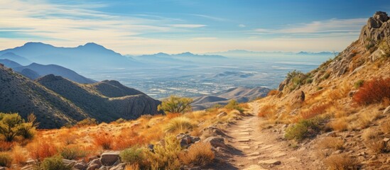 An autumn day along a mountain ridgeline offers a desert trail with a captivating view. Creative banner. Copyspace image