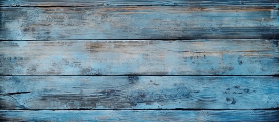 Fototapeta premium A copy space image of a wooden barn board with traces of faded blue paint creates a textured background