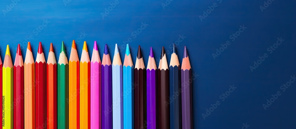 Poster A vibrant collection of colored pencils and school supplies displayed in a close up copy space image