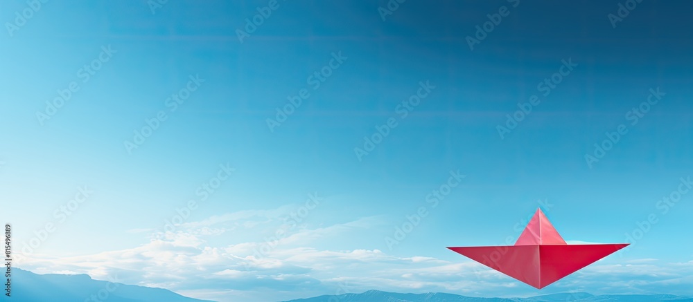 Poster a panoramic shot captures a leadership concept with a top view of a red paper plane on a blue backgr