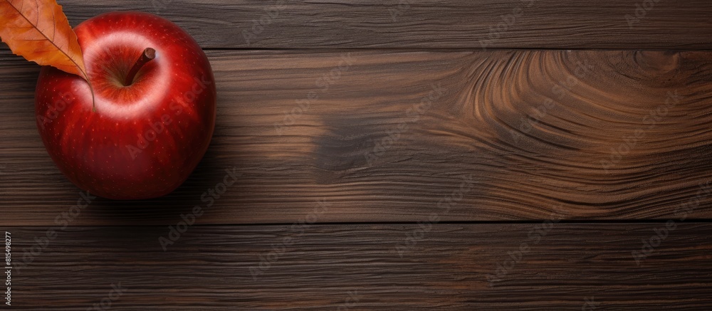 Poster A decorative flat wood apple shape is placed on a dark wood background creating a fall themed copy space image
