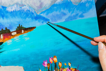 Painting a natural landscape of a azure lake with a brush