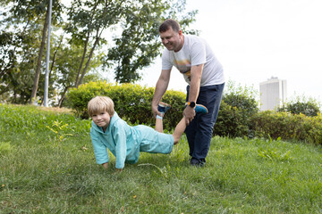 Dad and son are having fun in nature. family together on vacation. Healthy lifestyle, activity. enjoying the moment, a happy childhood, a pleasant pastime between father and son. Father's Day