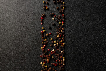 Colored peppercorns on a black background