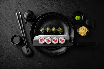 Tuna Maki. Sushi composition on black background. The Art of Japanese Cuisine. Food photography for...