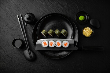 Salmon Maki. Sushi composition on black background. The Art of Japanese Cuisine. Food photography...