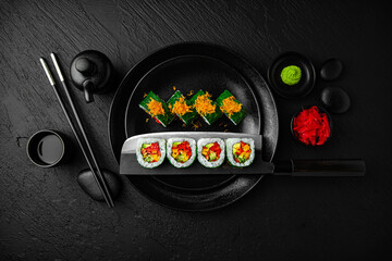 Vegan Roll. Sushi composition on black background. The Art of Japanese Cuisine. Food photography...