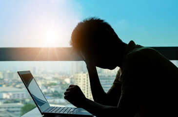 Man sitting down, his face unsettled. At the computer desk she has headaches and stress. Cause of...