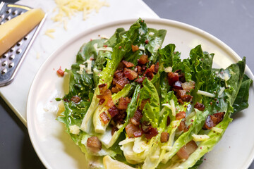 Cos lettuce salad with crispy bacon, and parmesan cheese. Easy healthy recipes.