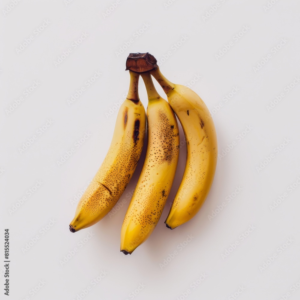 Wall mural three ripe bananas gracefully arranged on a pristine white background