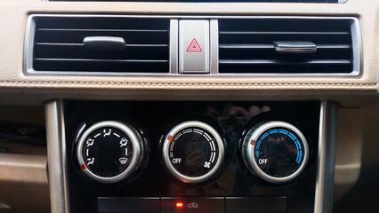 features on the front of the car cabin such as the Hazard light button between the AC ventilation...