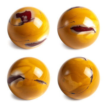 A variety of jasper - Yellow Mookaite. Stone sphere in four positions, isolated background. Collecting and magic concept. A hand-taken photo, not AI