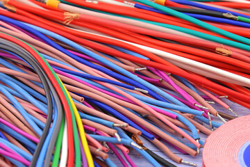 Copper electrical wiring wires in colored insulation for connecting electrical equipment. Close-up. Soft focus.