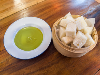 Pandan Kaya with Steamed Bread in bammboo basket. Steamed bun served with sweet green custard dip.
