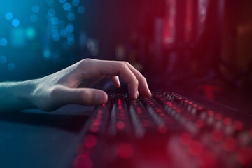 Hands, neon and typing on gaming keyboard computer in home for esports, internet or play video...