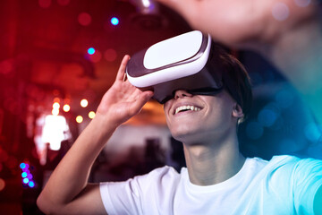 Man, gamer and virtual reality with high tech by neon for gaming, entertainment and home. VR, user...