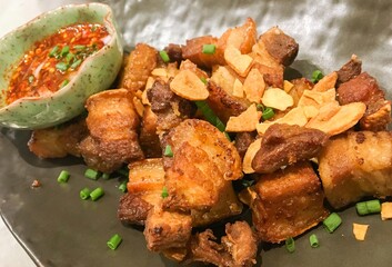 Crispy Pork Belly is a Thai style deep-fried Pork Belly Recipe in the restaurant. Crispy Fried Pork Belly with Thai dipping sauce.