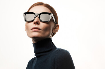 Studio portrait of a sexy girl in glasses with smoothed hair. Grain effect used