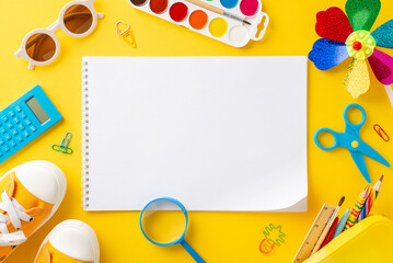 Early childhood summer enrichment theme. Top view of art essentials: sketchbook, colored pencils, paints, calculator, outdoor gear - sunhat, sunglasses, sneakers, pinwheel, and more on yellow backdrop