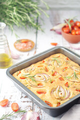 Italian home made bread focaccia with tomatoes and onions