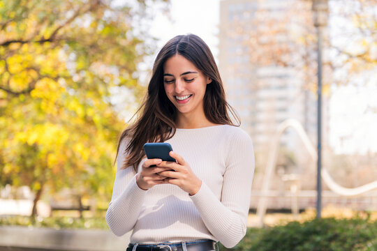 caucasian woman smiling happy using mobile phone