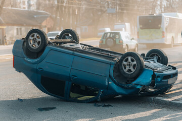 Road traffic accident. Overturned car on the highway. Severe damage to the vehicle. Close-up,...