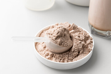 Whey protein powder in measuring scoop