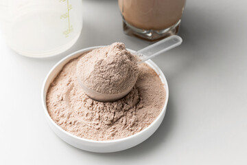 Whey protein powder in measuring scoop