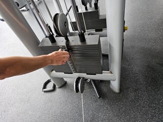 Person Using Exercise Machine in Gym