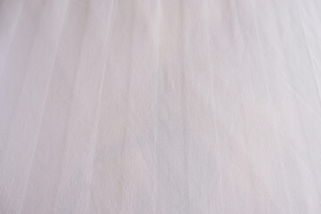 Obraz premium White bed sheet background. Close-up bedding sheet texture. White background for fibers and textiles, bedroom, cotton, hotel, and mattress. Abstract white fabric background with copy space.