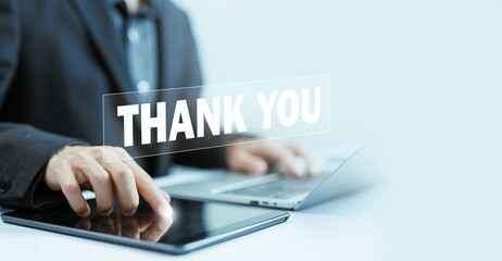 thank you business. businessman using a laptop and showing the message thank you on a display...