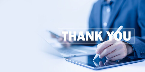 thank you business. businessman using a laptop and showing the message thank you on a display...