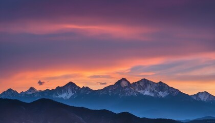 A mountain range outlined against a colorful sunse