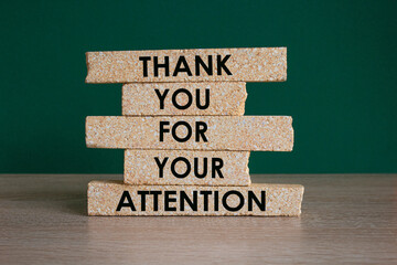 Attention symbol. Brick blocks with words Thank you for your attention. Beautiful wooden table,...
