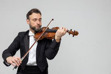 Elegant violinist playing passionately at concert