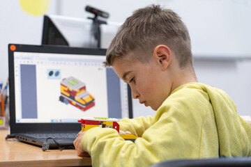 Concentrated child in a robotics workshop building a robot