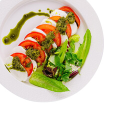 Fresh caprese salad with pesto drizzle
