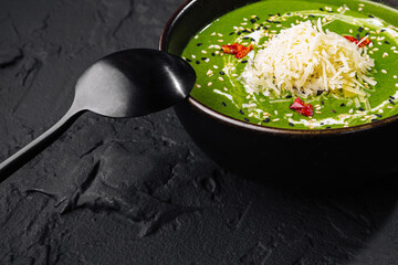 Creamy spinach soup with cheese garnish