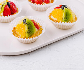 Fresh fruit tartlets on white plate