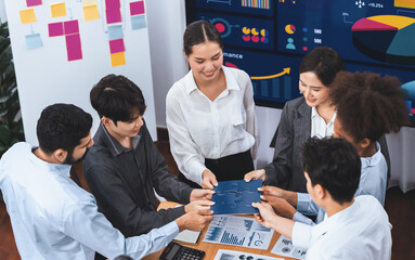 Corporate officer worker collaborate in office, connecting puzzle pieces with report paper on table...