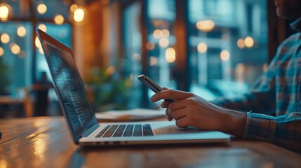 Business man using mobile phone and working on laptop computer at coffee shop. Student searching the information, studying online, work from cafe, distant job, business casual