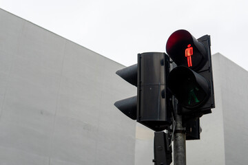 A close-up photo of a traffic light with a red pedestrian signal. Road traffic safety concept.