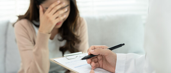 woman with mental health problems is consulting. psychiatrist is recording the patient's condition...