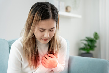 hand hold chest with heart attack symptoms, asian woman have chest pain caused by heart disease,...