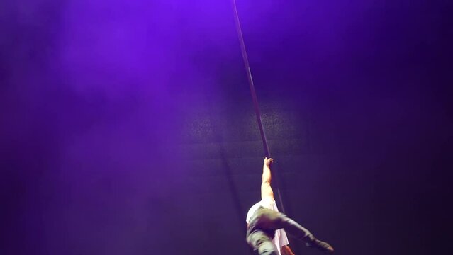 Handsome strong man pole dance.