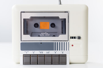 Obraz premium Step back in time with this vintage computer datasette, a charming relic from the 8-bit era, elegantly showcased against a clean white background.