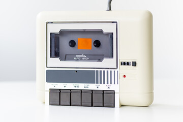 Fototapeta premium Step back in time with this vintage computer datasette, a charming relic from the 8-bit era, elegantly showcased against a clean white background.