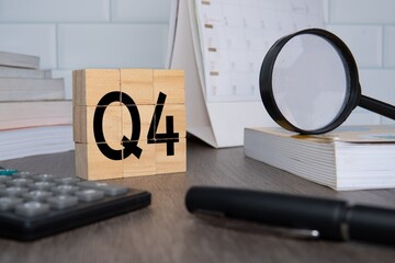 Close up image of wooden cubes with alphabet Q4 on office desk. Fourth quarter concept.